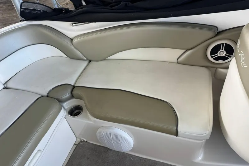 Slide: The Image of 2006 Sea Ray 240 Sundeck interior seating with beige and white upholstery. - 5
