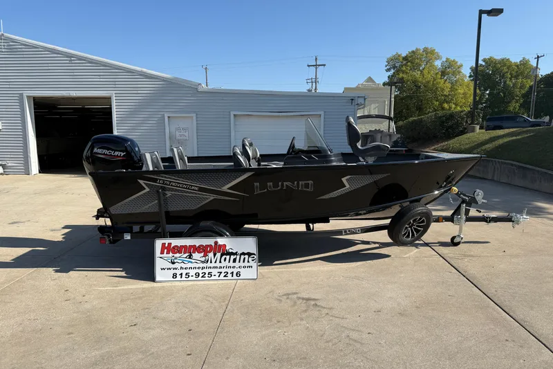 Slide: The Image of 2026 Lund 1675 Adventure SS boat on trailer at Hennepin Marine dealership. - 1