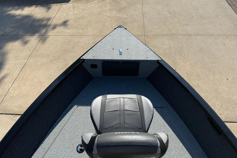 Slide: The Image of 2026 Lund 1675 Adventure SS boat interior with a single seat, viewed from above. - 10