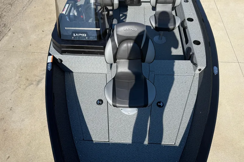 Slide: The Image of 2026 Lund 1675 Adventure SS boat interior with seating and console, viewed from above. - 11