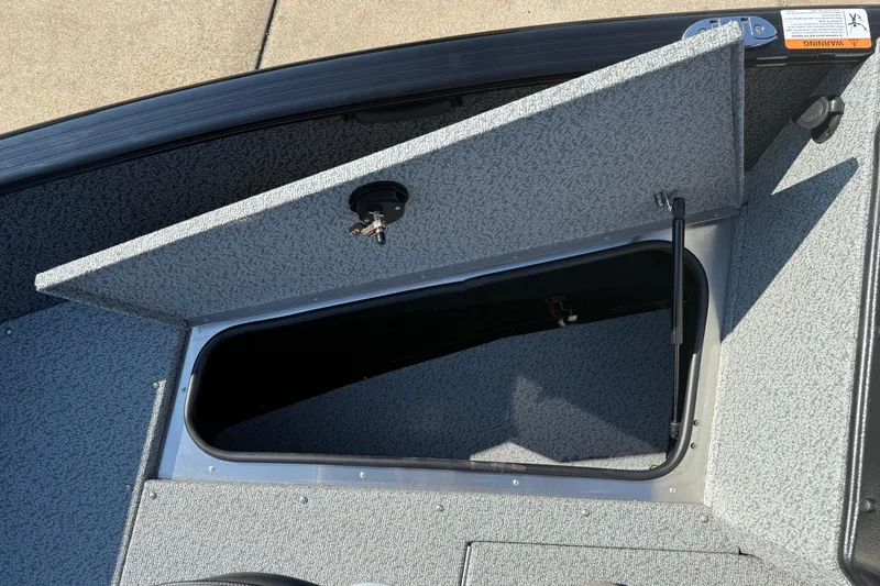Slide: The Image of Open storage compartment on 2026 Lund 1675 Adventure SS boat, showcasing interior space. - 12