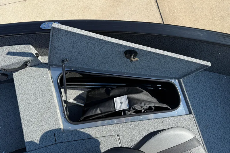 Slide: The Image of Open storage compartment in 2026 Lund 1675 Adventure SS boat, showing interior space. - 13