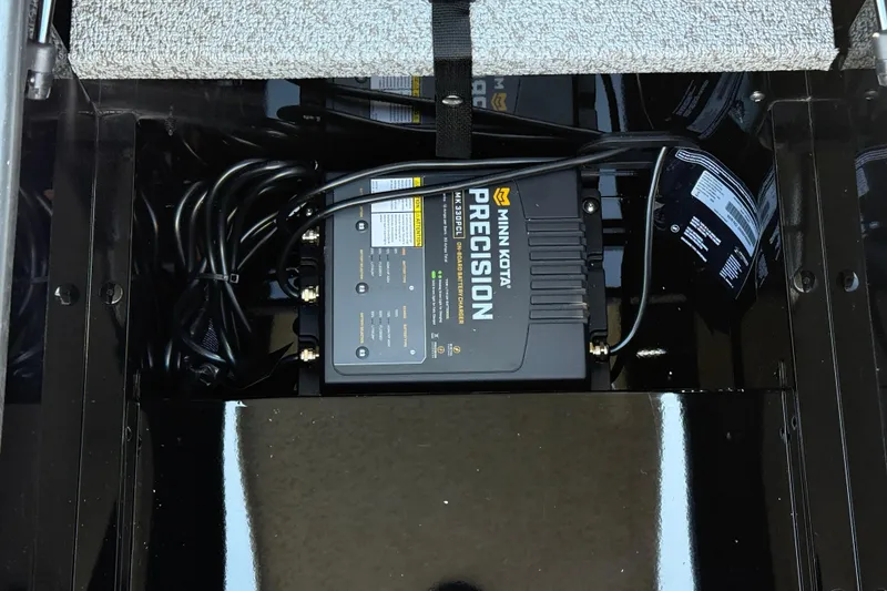 Slide: The Image of Minn Kota Precision charger in 2026 Lund 1675 Adventure SS boat compartment. - 15