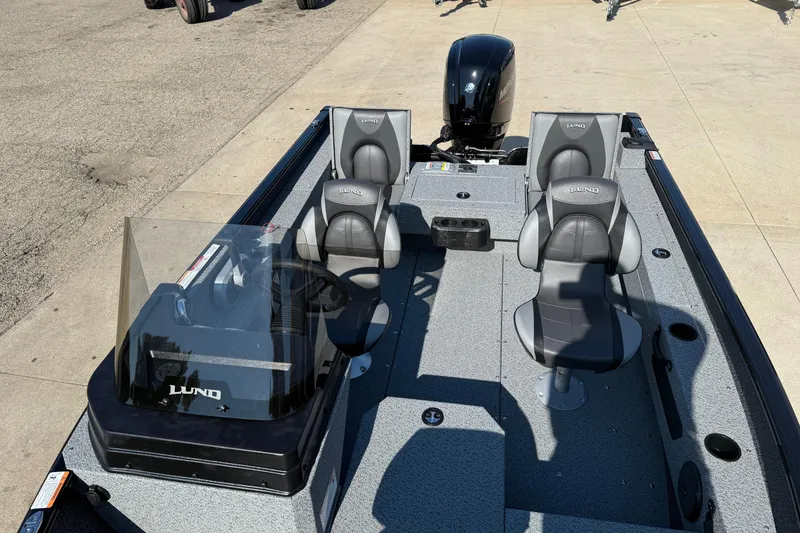 Slide: The Image of 2026 Lund 1675 Adventure SS boat interior with four seats and steering console. - 16