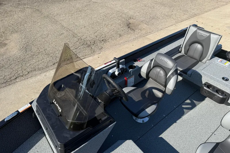 Slide: The Image of 2026 Lund 1675 Adventure SS boat interior with steering console and seating. - 17