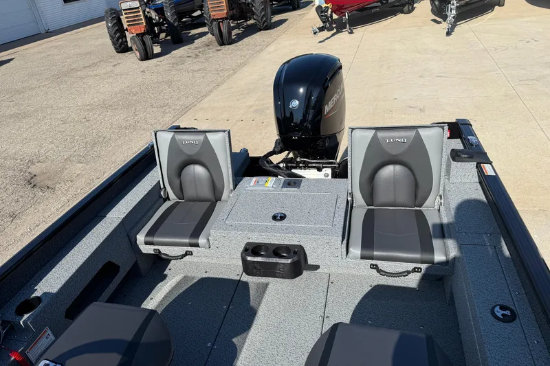 Slide: The Image of 2026 Lund 1675 Adventure SS boat interior with dual seats and Mercury outboard motor. - 23