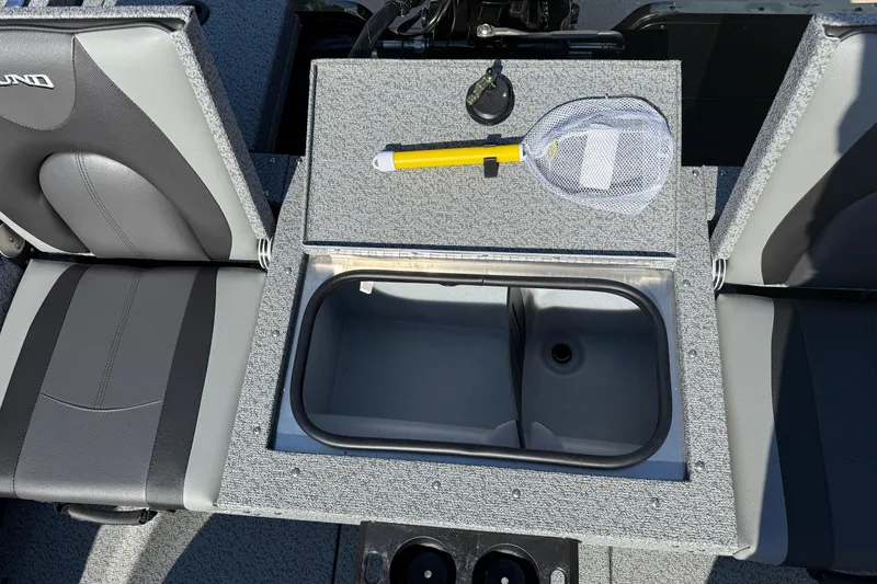 Slide: The Image of 2026 Lund 1675 Adventure SS boat interior with storage compartment and fishing net. - 25