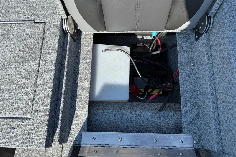 Slide: The Image of 2026 Lund 1675 Adventure SS boat interior showing storage compartment and wiring. - 26