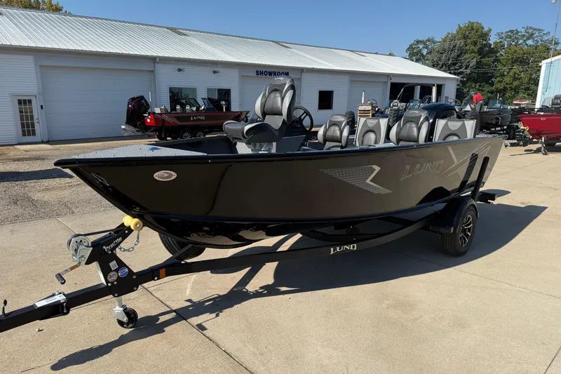 Slide: The Image of 2026 Lund 1675 Adventure SS boat on trailer outside showroom. - 4