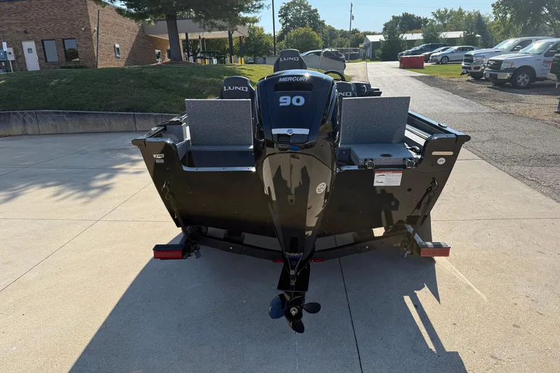 Slide: The Image of 2026 Lund 1675 Adventure SS boat with Mercury 90 engine, parked outdoors. - 7