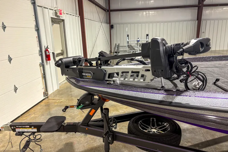 Slide: The Image of 2026 Skeeter ZXR 19 boat with Minn Kota motor in a garage setting. - 5