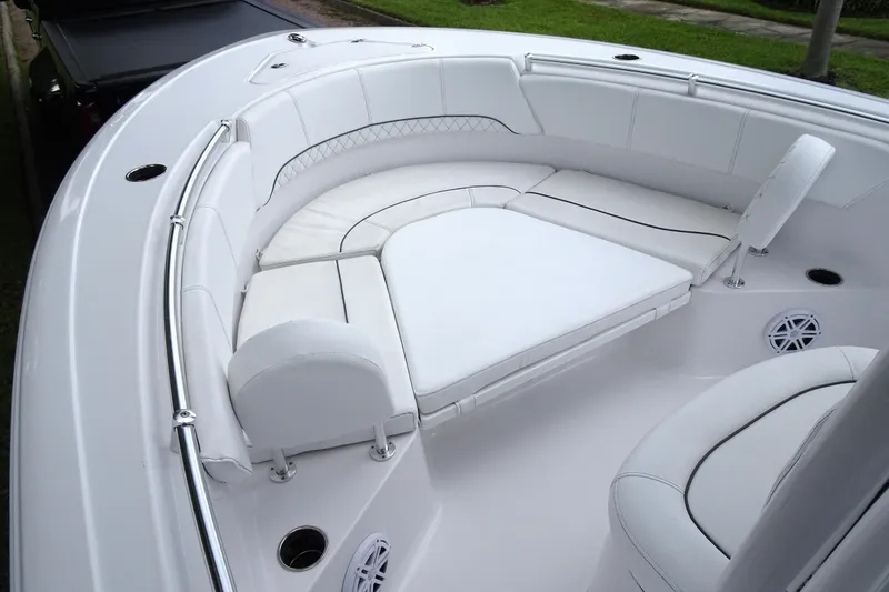 Slide: The Image of 2023 Sportsman Heritage 231 Center Console boat with white cushioned seating area. - 14