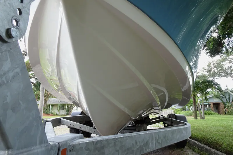 Slide: The Image of 2023 Sportsman Heritage 231 Center Console boat on trailer, viewed from below. - 18