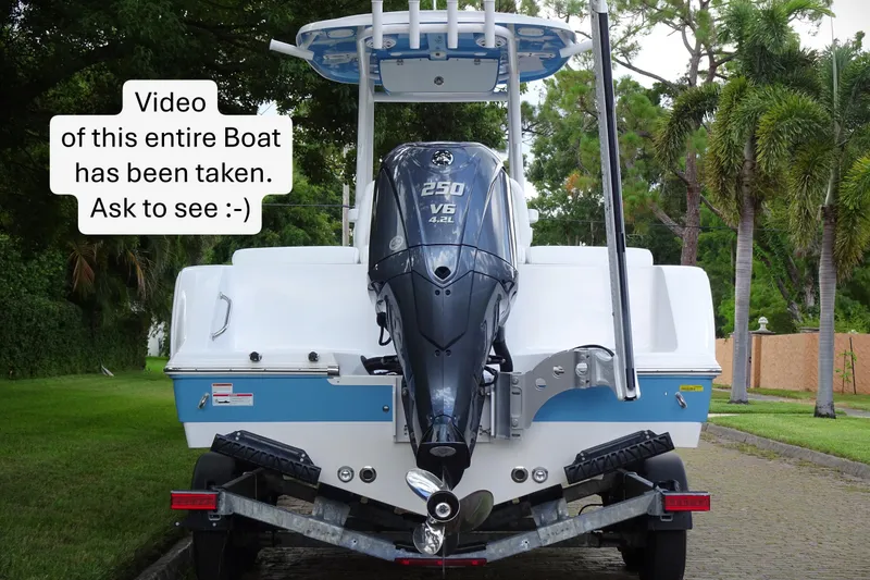 Slide: The Image of 2023 Sportsman Heritage 231 Center Console boat with outboard motor on trailer. - 2