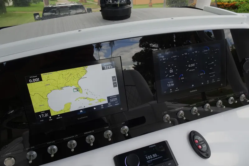 Slide: The Image of 2023 Sportsman Heritage 231 Center Console dashboard with Garmin navigation displays and control switches. - 21