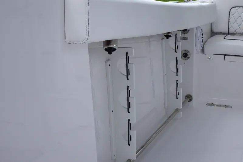 Slide: The Image of 2023 Sportsman Heritage 231 Center Console interior with rod holders and seating. - 6