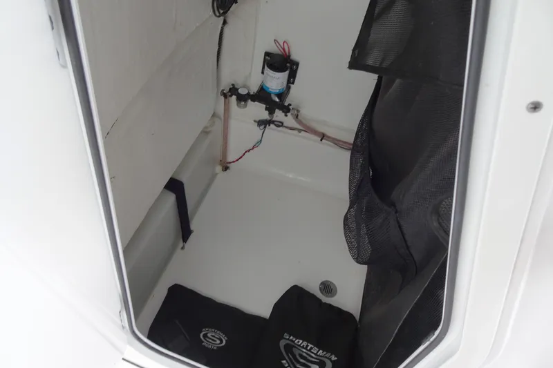 Slide: The Image of 2023 Sportsman Heritage 231 Center Console storage compartment with pump and accessories. - 8