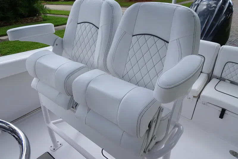 Slide: The Image of 2023 Sportsman Heritage 231 Center Console boat with luxurious white seating and diamond stitching. - 9