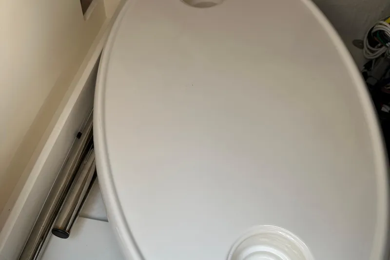 Slide: The Image of 2024 Chaparral 26 Surf boat interior detail, featuring sleek white surface design. - 14