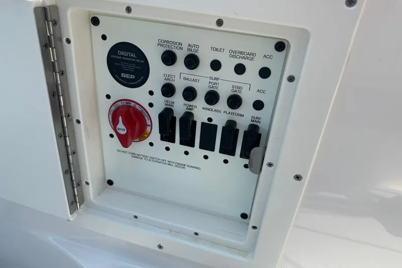 Slide: The Image of Control panel of 2024 Chaparral 26 Surf boat with various switches and indicators. - 17