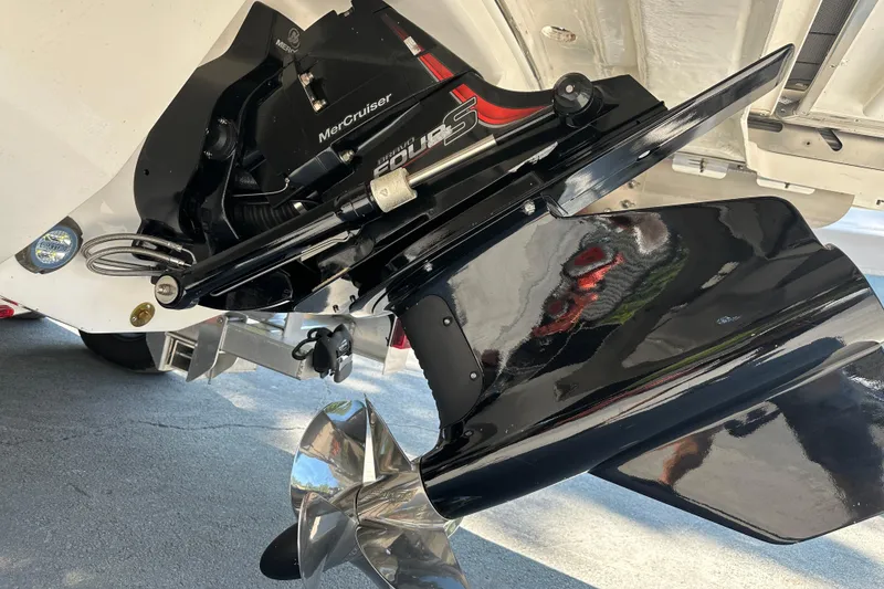 Slide: The Image of 2024 Chaparral 26 Surf boat with MerCruiser engine and propeller detail. - 22