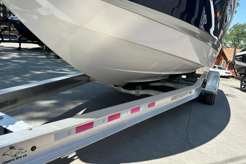 Slide: The Image of 2024 Chaparral 26 Surf boat on a trailer, showcasing sleek hull design. - 25