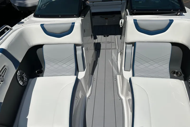 Slide: The Image of 2024 Chaparral 26 Surf boat interior with white and blue seating, modern design. - 4