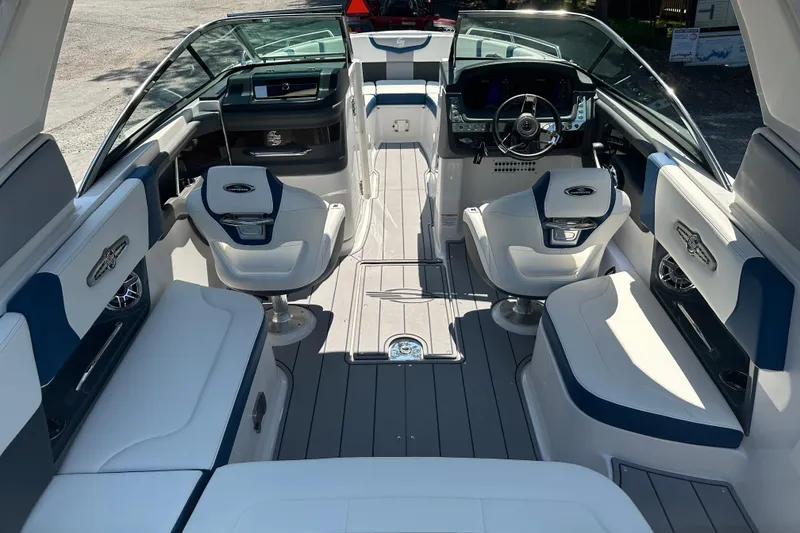 Slide: The Image of 2024 Chaparral 26 Surf boat interior with modern seating and sleek dashboard design. - 9