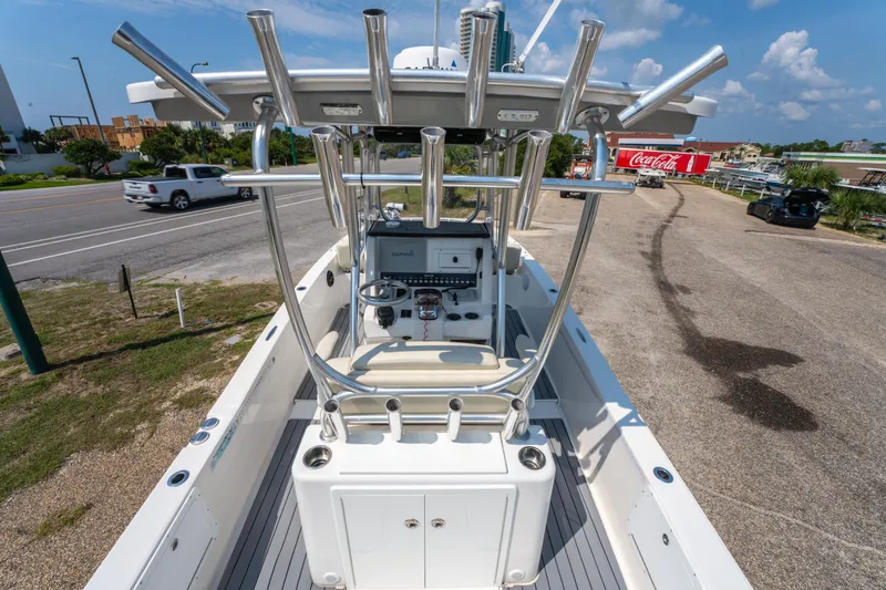 Slide: The Image of 2020 Sea Cat 26 Hybrid boat with T-top and fishing rod holders, parked near a road. - 15