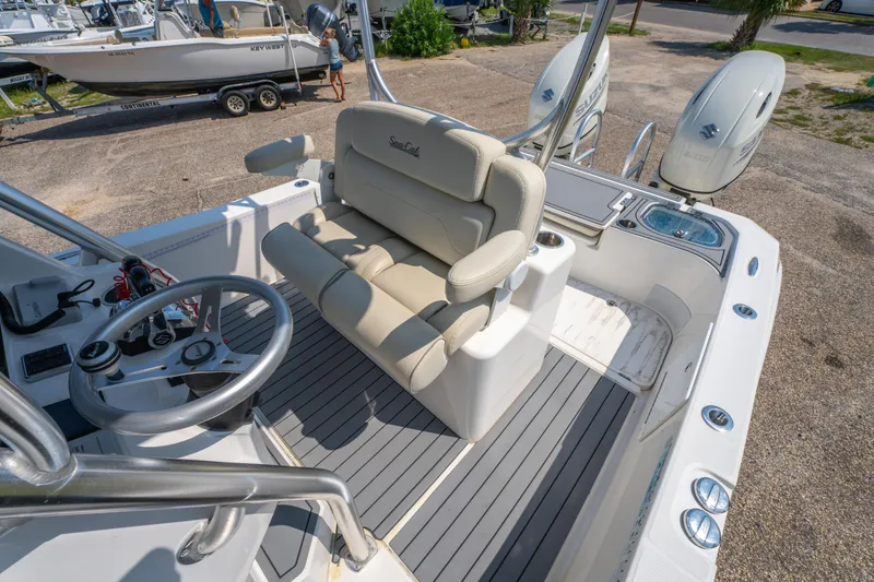 Slide: The Image of 2020 Sea Cat 26 Hybrid boat interior with steering wheel and seating, featuring dual Suzuki engines. - 16