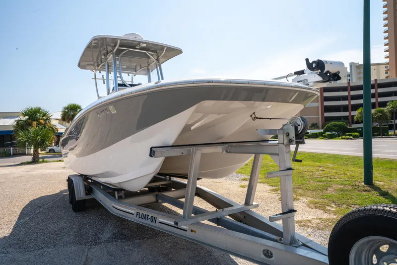Slide: The Image of 2020 Sea Cat 26 Hybrid boat on trailer, parked outdoors under clear sky. - 2