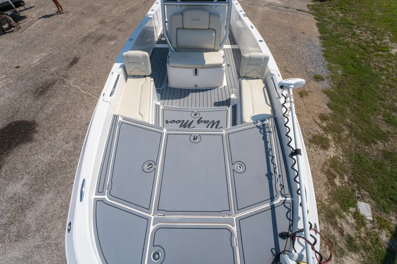 Slide: The Image of 2020 Sea Cat 26 Hybrid boat with spacious deck and seating, docked on concrete. - 26