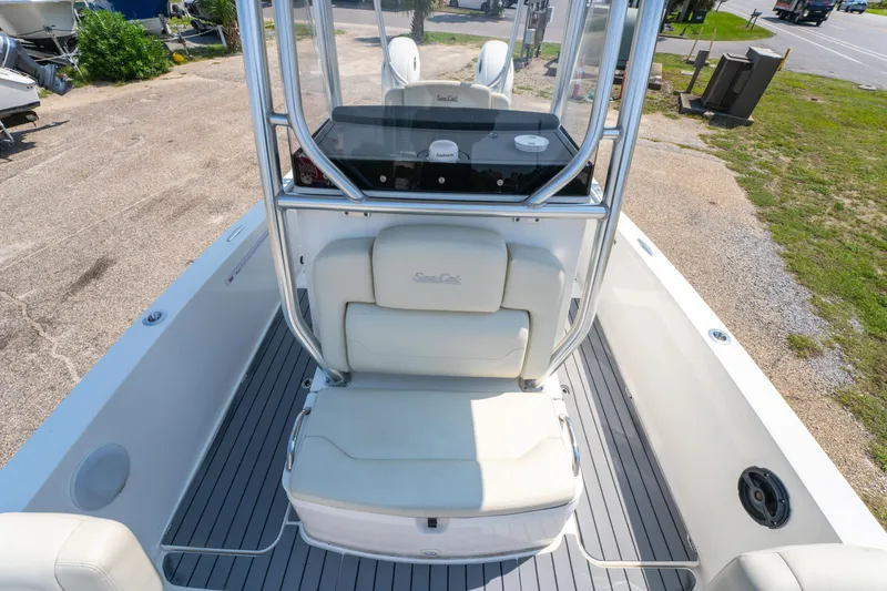 Slide: The Image of 2020 Sea Cat 26 Hybrid boat interior with seating and console, docked outdoors. - 29