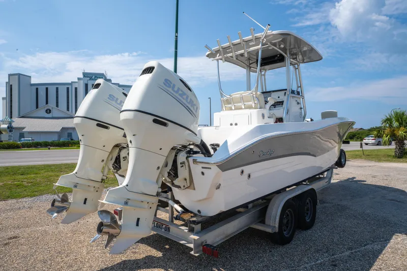 Slide: The Image of 2020 Sea Cat 26 Hybrid boat with dual Suzuki engines on a trailer. - 3