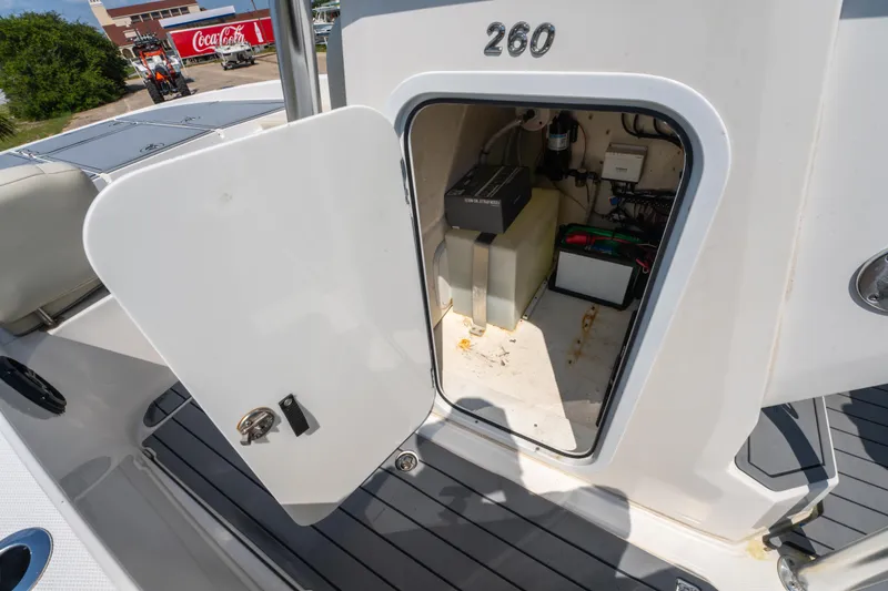 Slide: The Image of Open storage compartment on 2020 Sea Cat 26 hybrid boat, showing interior equipment. - 30