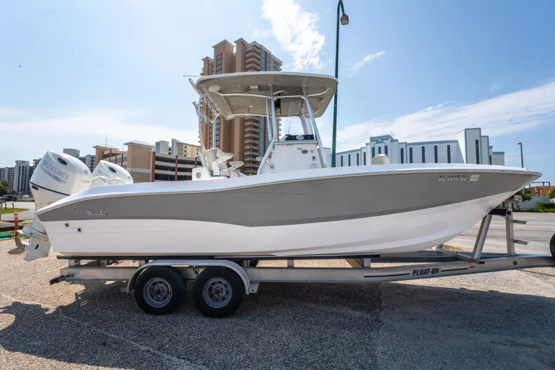Slide: The Image of 2020 Sea Cat 26 Hybrid boat on trailer, cityscape background, sunny day. - 6