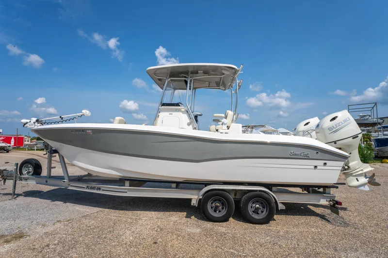 Slide: The Image of 2020 Sea Cat 26 Hybrid boat on trailer under clear blue sky. - 7