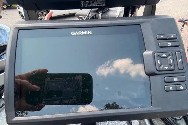 Slide: The Image of Garmin device on 2005 Triton Tr-186 DC boat, reflecting sky and person taking photo. - 11
