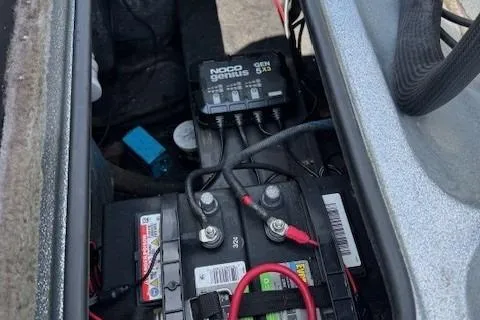 Slide: The Image of Battery compartment of 2005 Triton Tr-186 DC with NOCO Genius charger. - 13