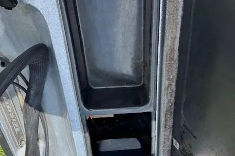 Slide: The Image of Storage compartment of a 2005 Triton Tr-186 DC boat, showing interior details. - 14
