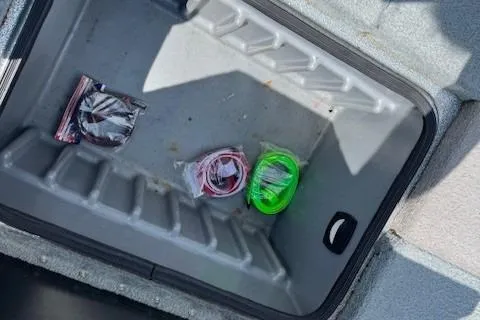 Slide: The Image of Storage compartment of a 2005 Triton Tr-186 DC boat with organized cables. - 16