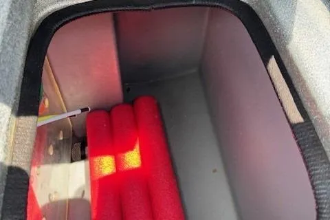 Slide: The Image of Storage compartment of a 2005 Triton Tr-186 DC boat with red padding. - 17