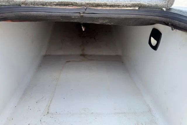 Slide: The Image of Storage compartment of a 2005 Triton Tr-186 DC boat, showing interior space. - 22