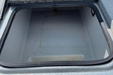 Slide: The Image of Open storage compartment in a 2005 Triton Tr-186 DC boat. - 23