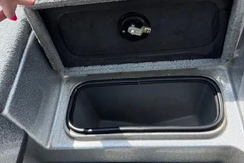 Slide: The Image of 2005 Triton Tr-186 DC storage compartment with open lid, showing interior space. - 24