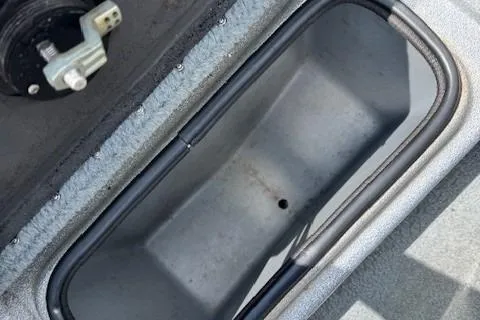 Slide: The Image of 2005 Triton Tr-186 DC boat compartment with water and drainage hole. - 25