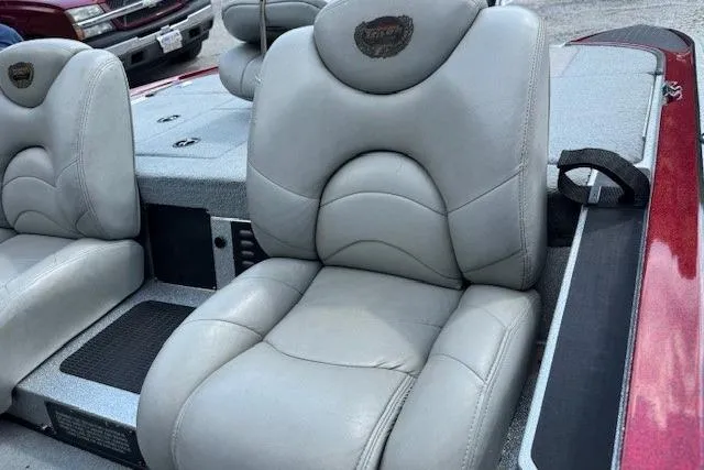 Slide: The Image of 2005 Triton Tr-186 DC boat seats with gray upholstery and logo detail. - 3