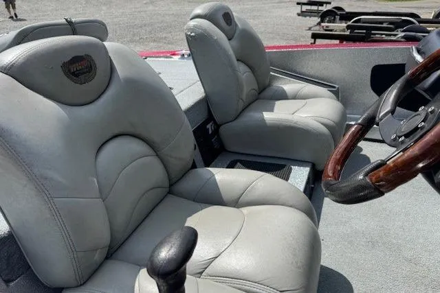Slide: The Image of 2005 Triton Tr-186 DC boat interior with gray leather seats and wooden steering wheel. - 6