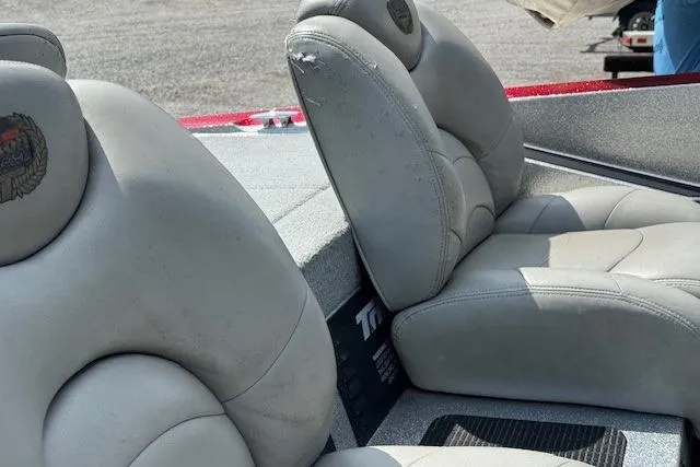 Slide: The Image of 2005 Triton Tr-186 DC boat seats with light wear, featuring gray upholstery. - 7