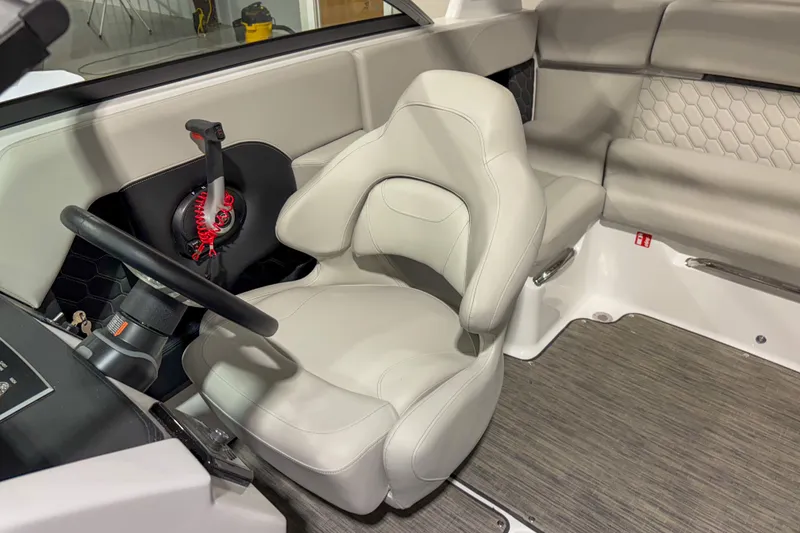 Slide: The Image of 2026 Four Winns H2 boat interior with white captain's seat and steering wheel. - 8
